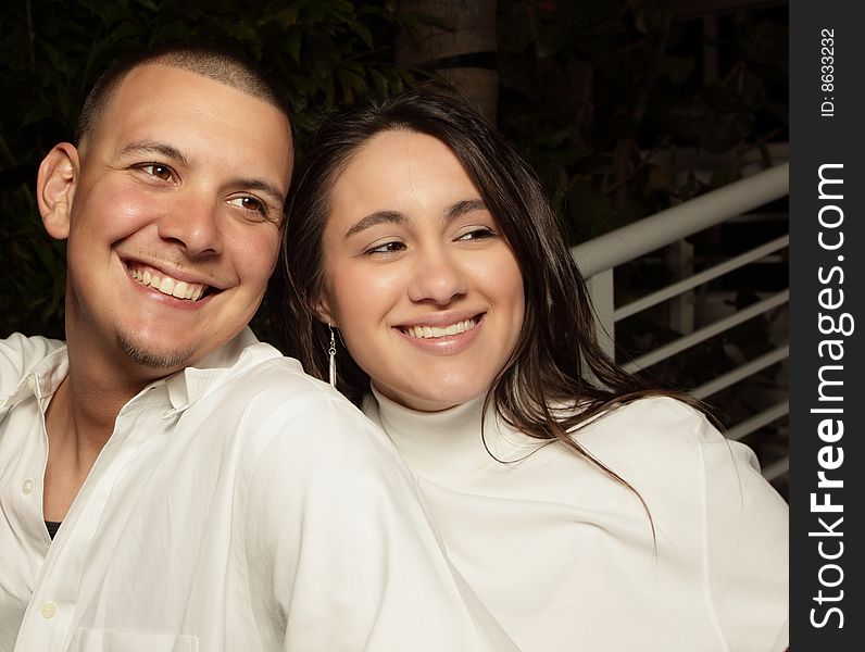 Young couple smiling and glancing away