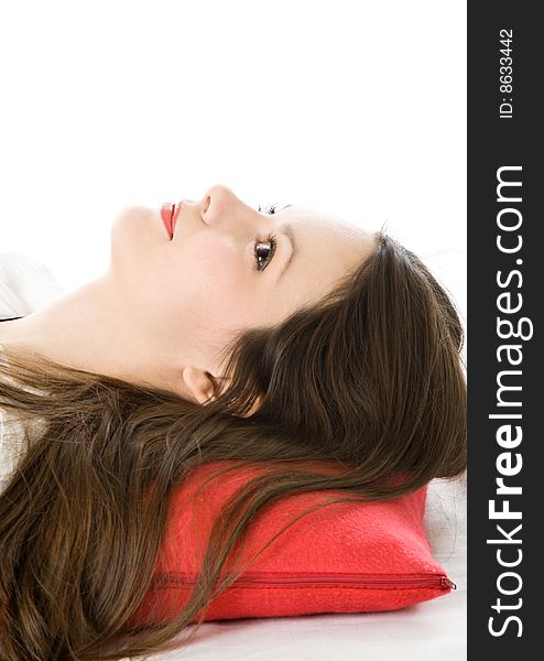 Young woman on red pillow isolated on white background