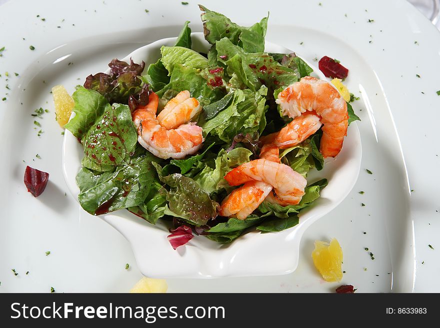 Delicious shrimps over a fresh green salad