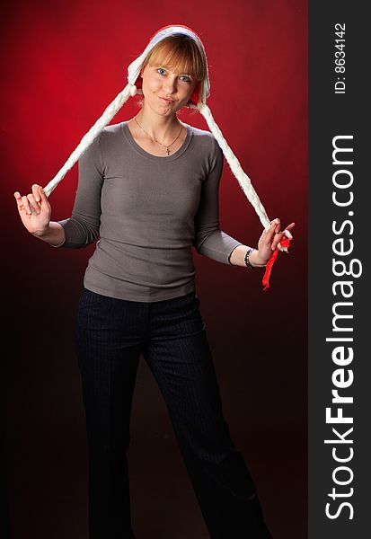 Woman wearing a santa hat on a red background