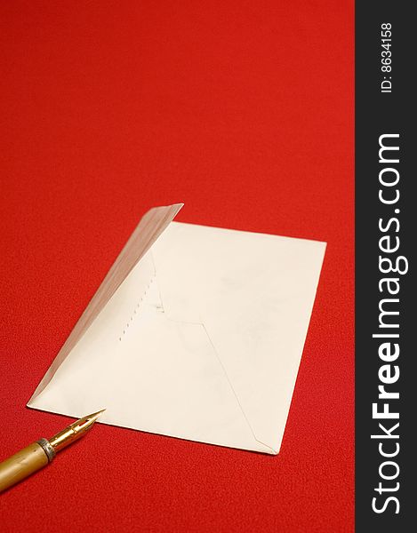 Envelope and pen on red backgrounds. Envelope and pen on red backgrounds