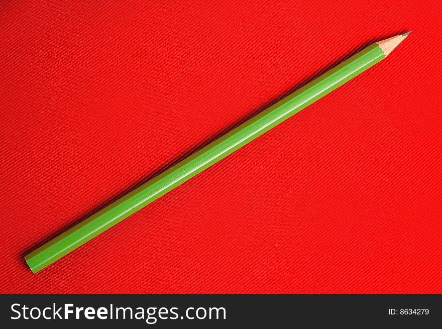 Sharpened pencil on red backgrounds