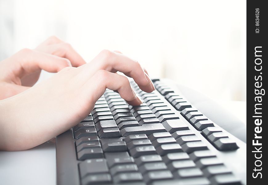 Girl hands typing on the background. Girl hands typing on the background