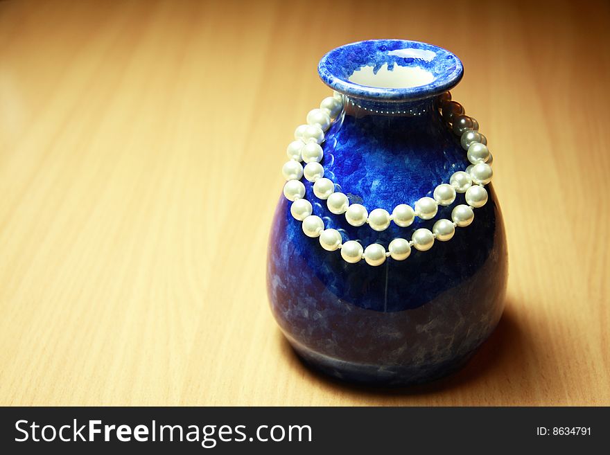 Blue vase and white necklace. Blue vase and white necklace