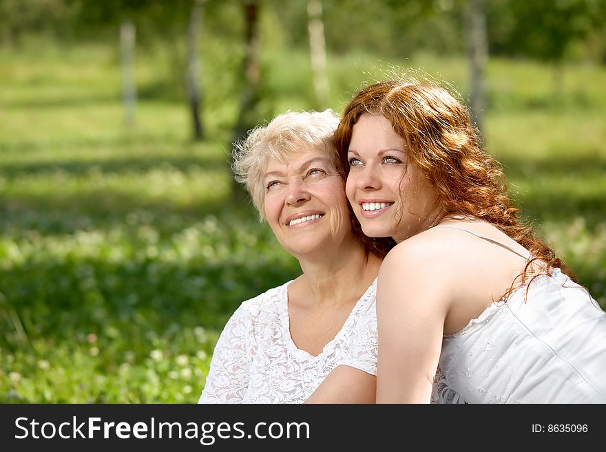 Happy daughter and mother in a summer garden. Happy daughter and mother in a summer garden