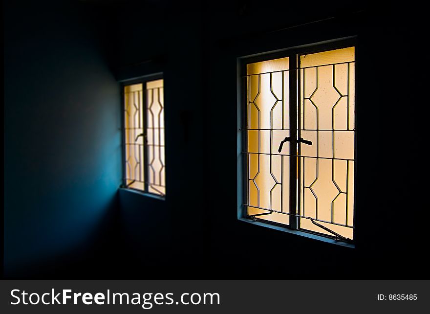 Two windows in dark room