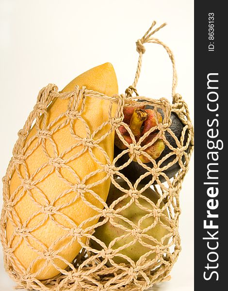 An exotic macrame basket of exotic fruit. An exotic macrame basket of exotic fruit