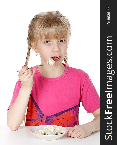 A girl eats meat dumplings it is isolated on a white background