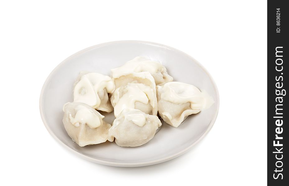 A dish with meat dumplings is isolated on a white background