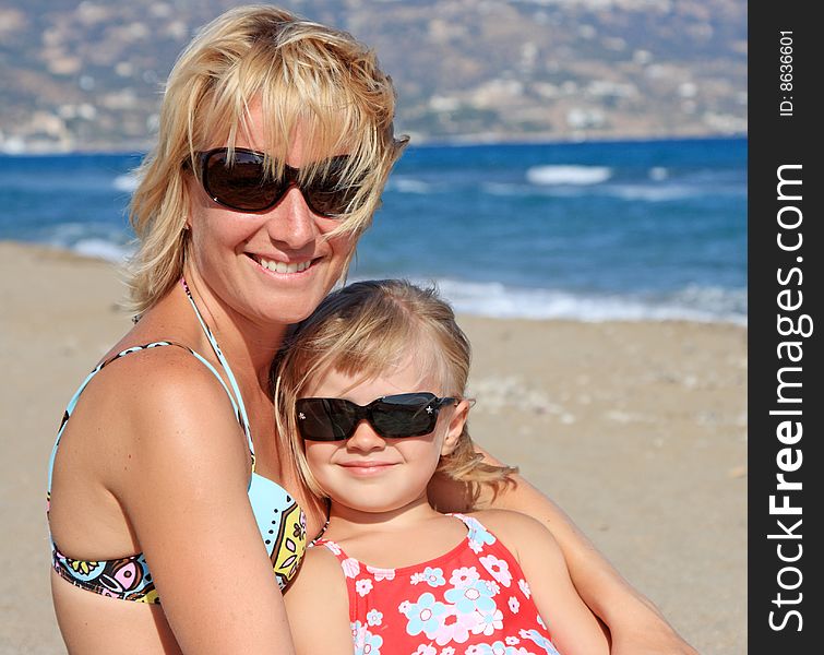 Happy mum with a daughter have a rest on the sea