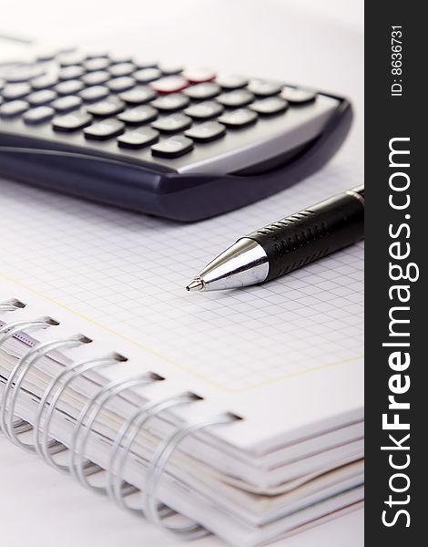 Pen and calculator (business background). Pen and calculator (business background)
