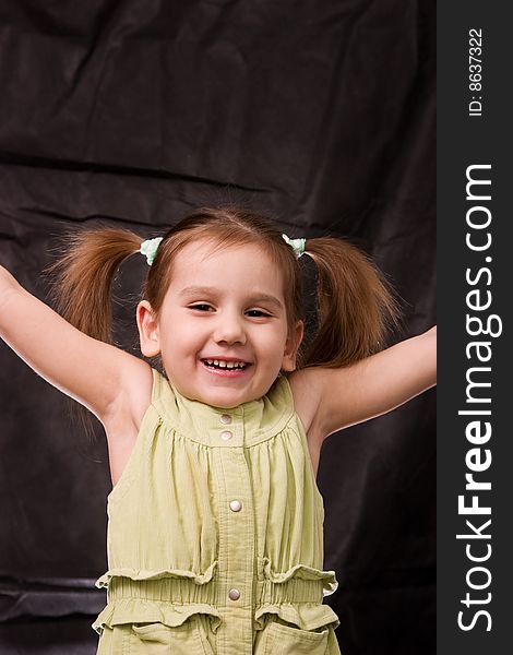 Playful girl on the black background