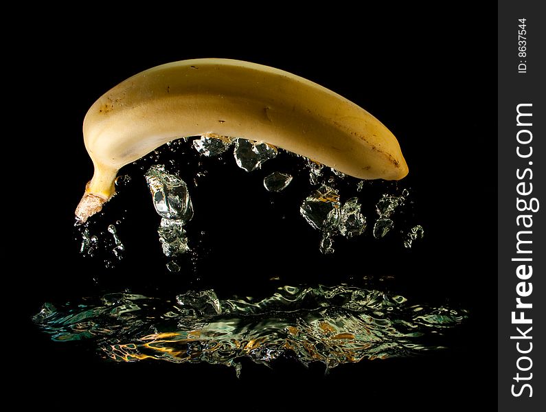 Banana in water on a black background