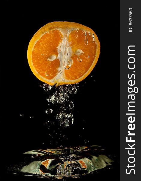 Orange in water on a black background