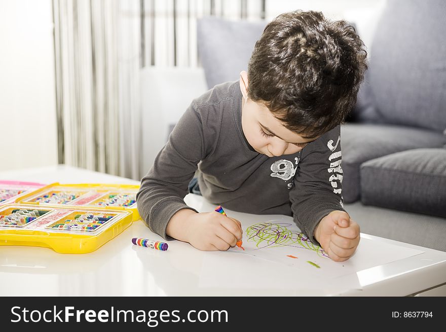 A young boy creates a self portrait with paint. A young boy creates a self portrait with paint.