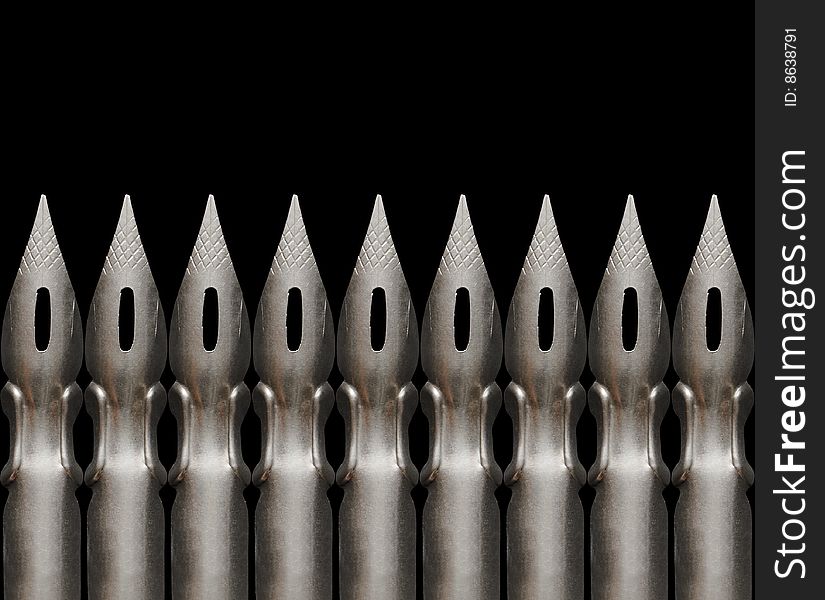 Close-up of few old steel pens isolated on dark background. Close-up of few old steel pens isolated on dark background