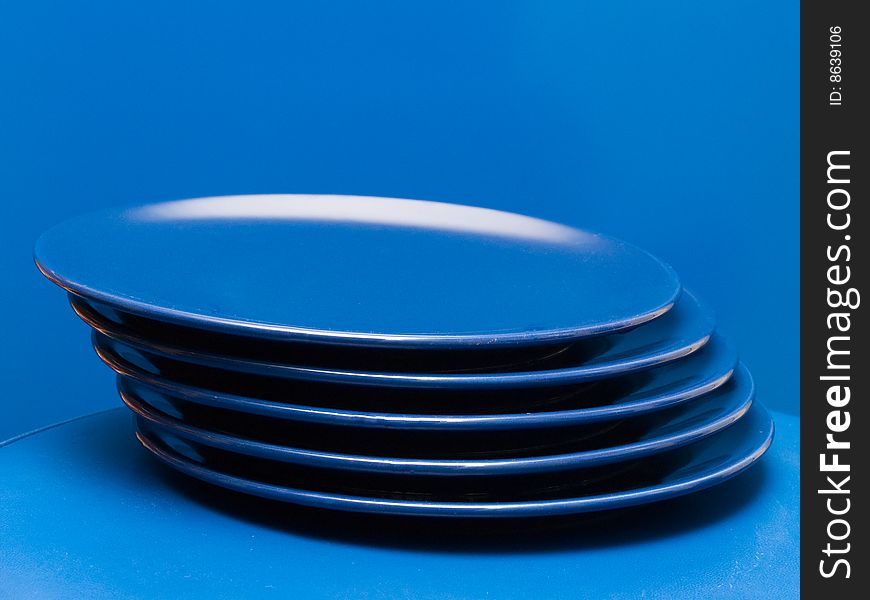 Stack of blue plates on a blue background. Stack of blue plates on a blue background