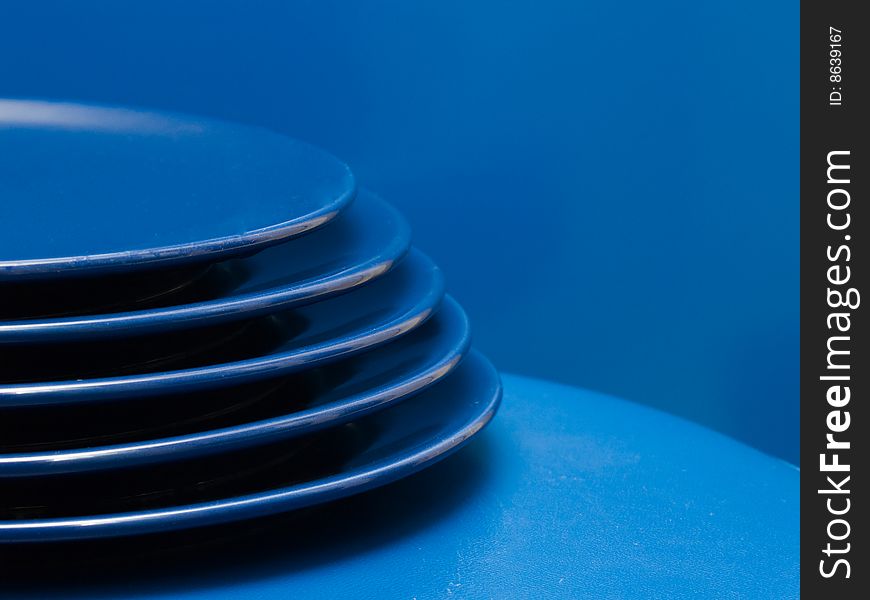 Stack of blue plates on a blue background