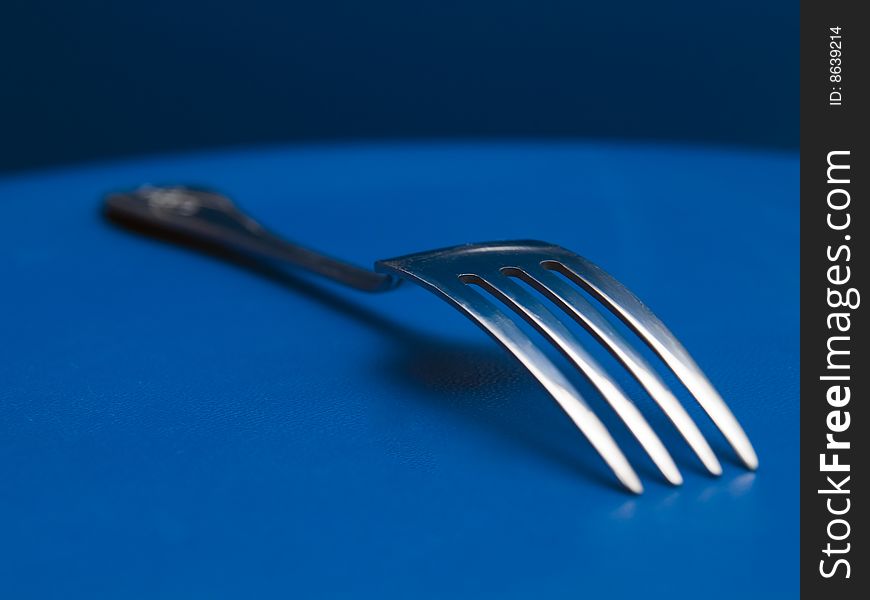 Still fork on a blue background