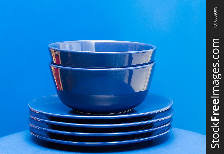 Stack of blue plates and bowls