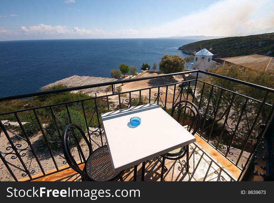 Two chears and table on balcony over sea. Two chears and table on balcony over sea