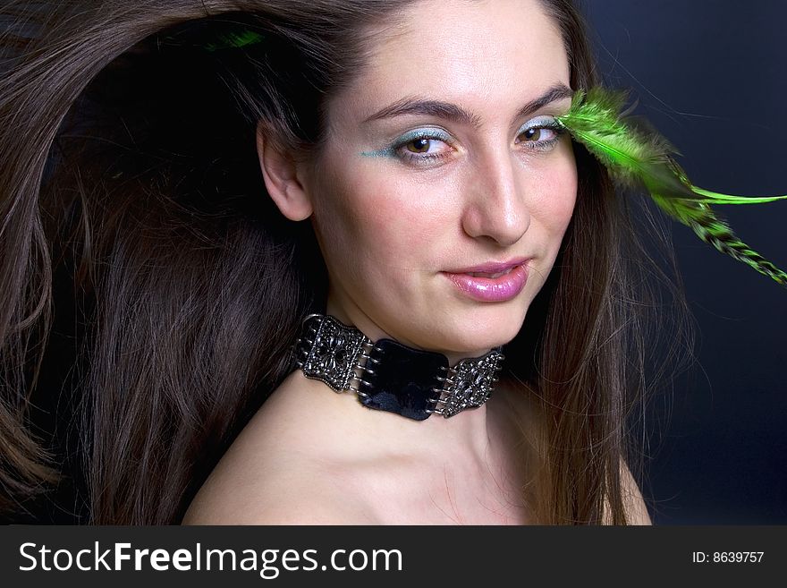 Portrait beautiful woman with blowing hair and make-up with feathers. Portrait beautiful woman with blowing hair and make-up with feathers