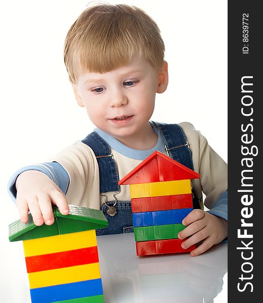 The child the boy plays cubes on a white background