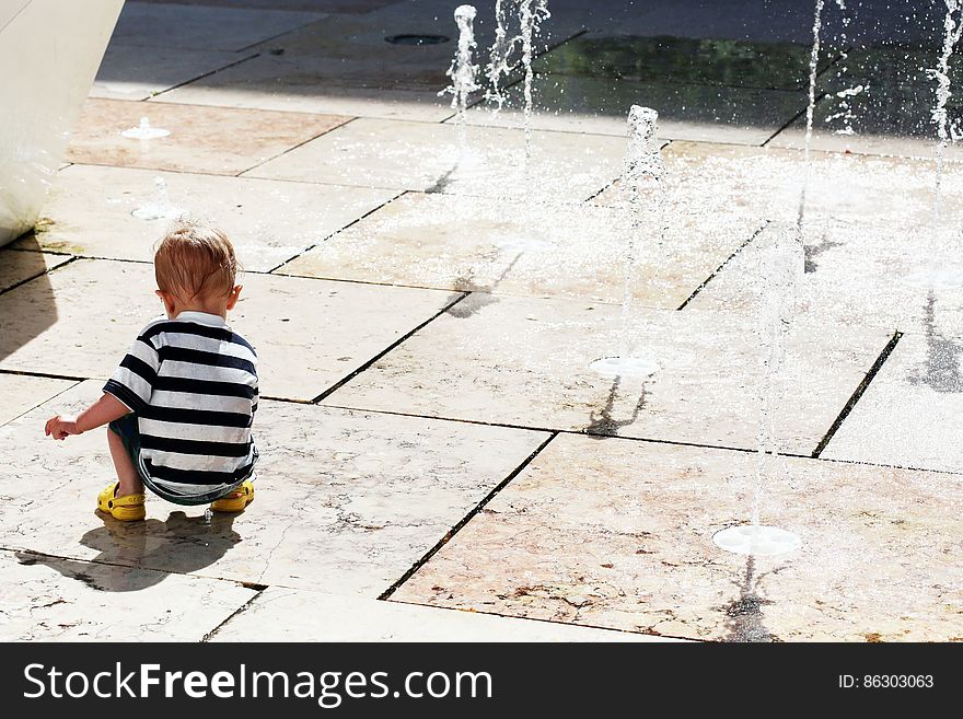 Child Plays With Water Jets