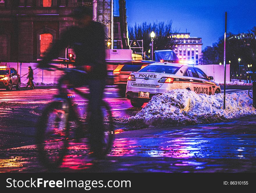 A man bicycles past a Secret Service police car outside the White House on a snowy day in Washington, DC. Dedicated to the public domain with a CC0 license. A man bicycles past a Secret Service police car outside the White House on a snowy day in Washington, DC. Dedicated to the public domain with a CC0 license.