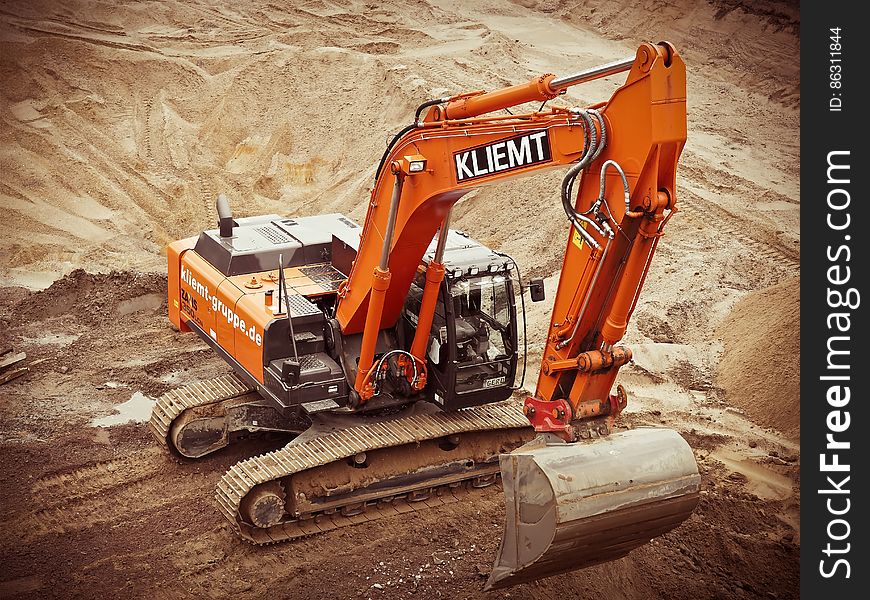 Orange Kliemt Excavator on Brown Soil