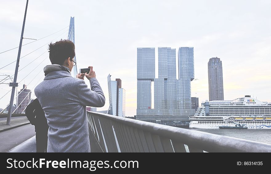 Rear View Of Man Photographing Cityscape