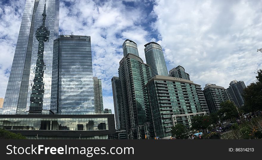 Low Angle View of Skyscrapers Against Cloudy Sky