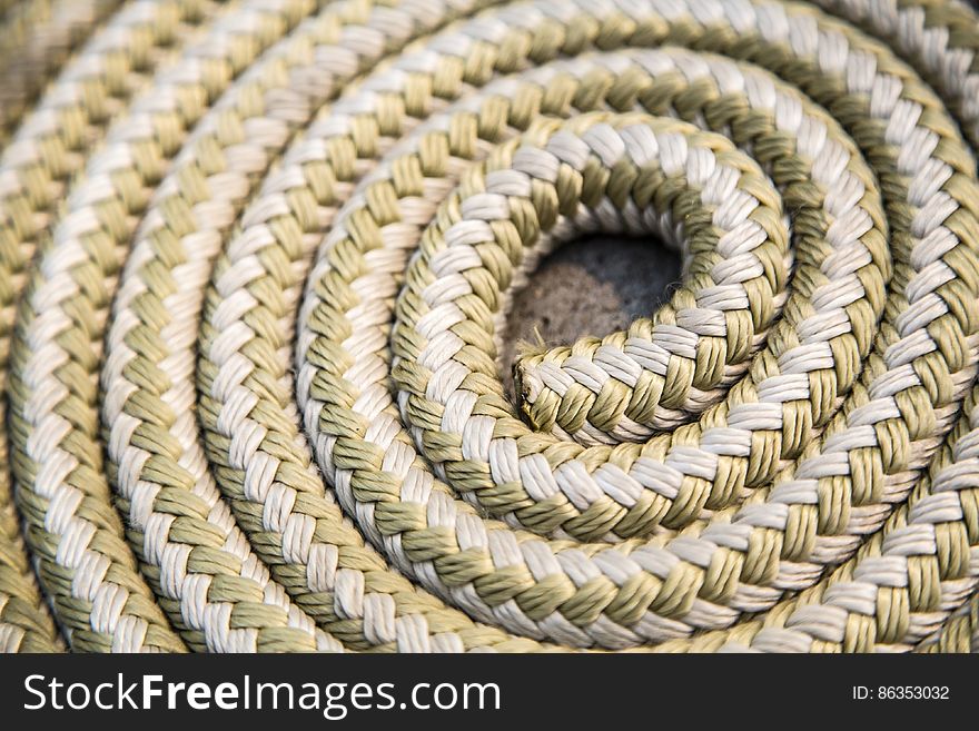 A close up of a length of a rope coiled up. A close up of a length of a rope coiled up.