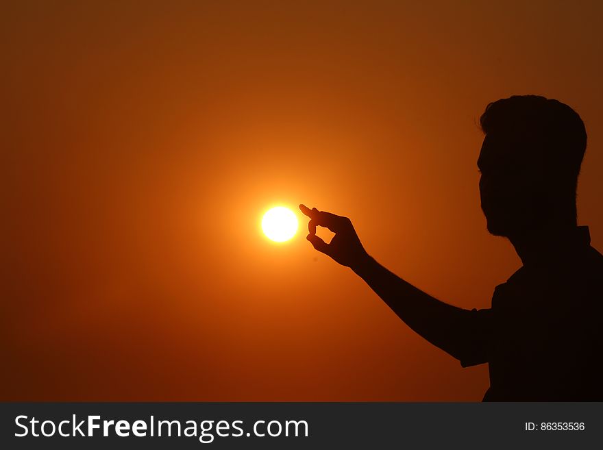 Silhouette of Woman Against Sunset