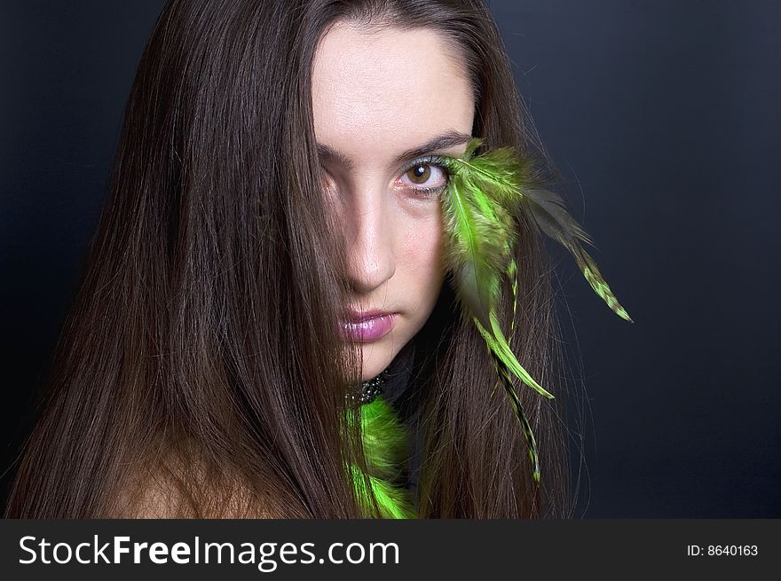 Portrait beautiful woman with long hair and feathers. Portrait beautiful woman with long hair and feathers