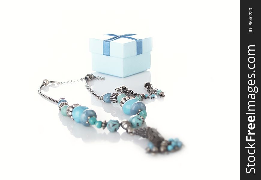 Beautiful necklace and small box on a white background. Beautiful necklace and small box on a white background