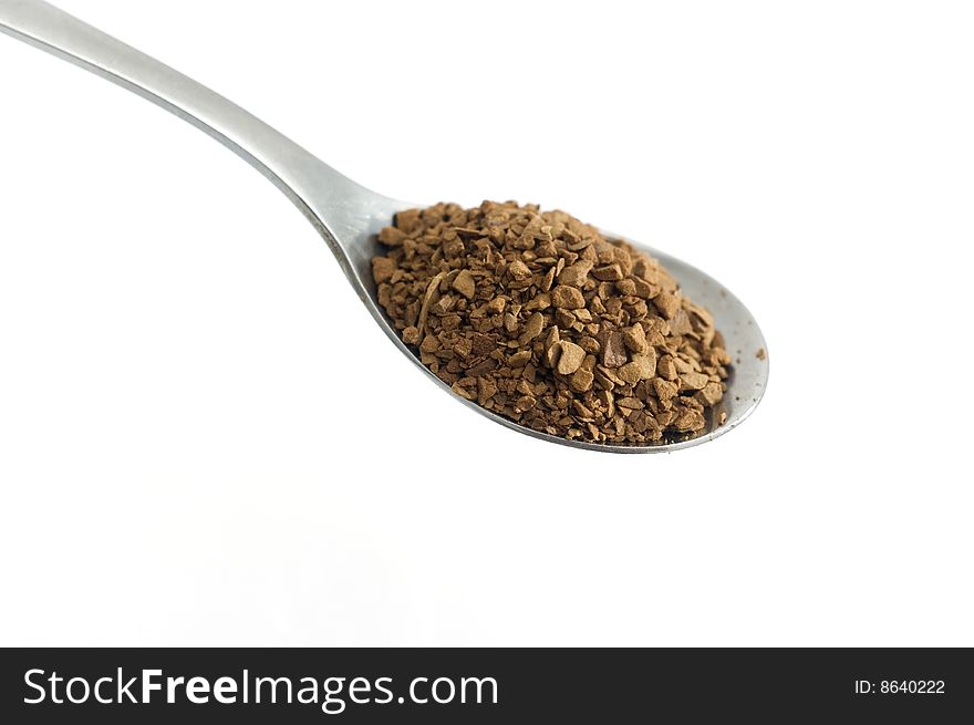 A spoon with instant coffee on white, macro