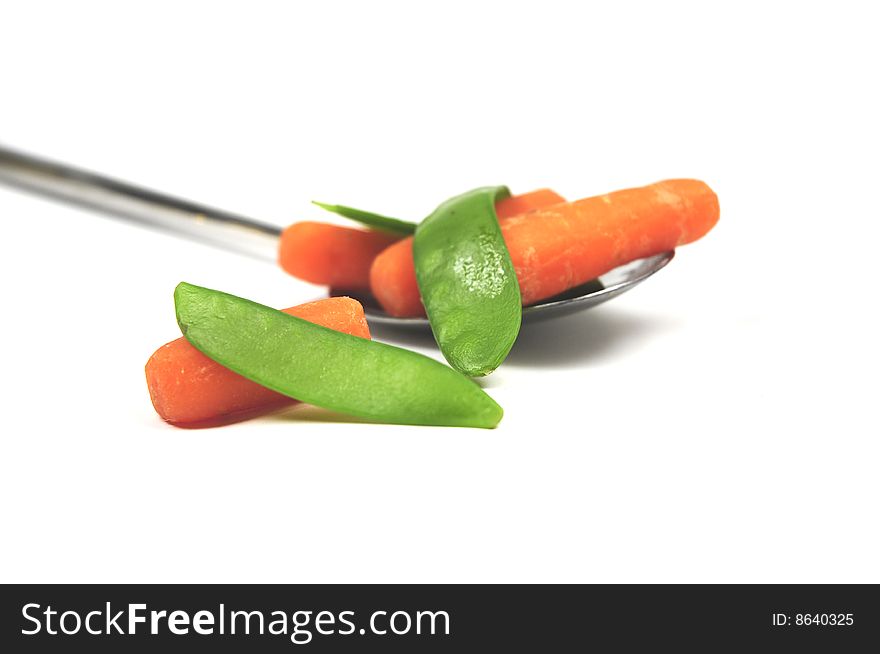 Some cooked vegetables on a spoon