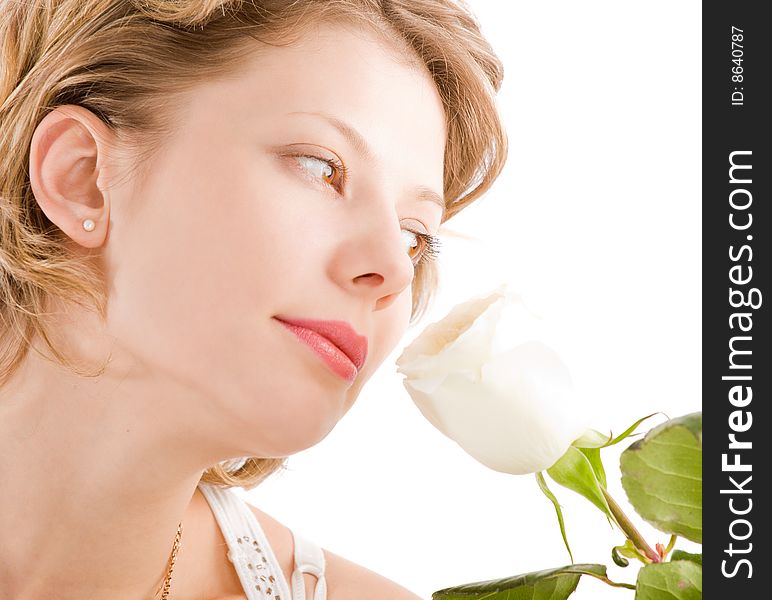 Portrait of attractive blond girl smelling rose