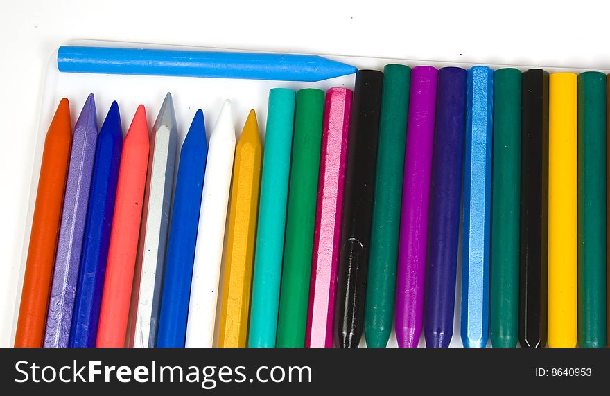 A vertical number of wax pencils with one blue horizontal