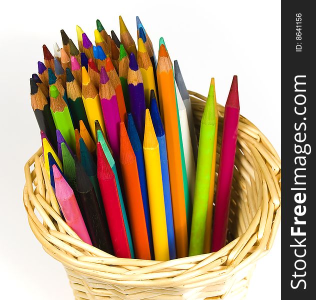 Set of color wooden and woodless pencils in a bast basket