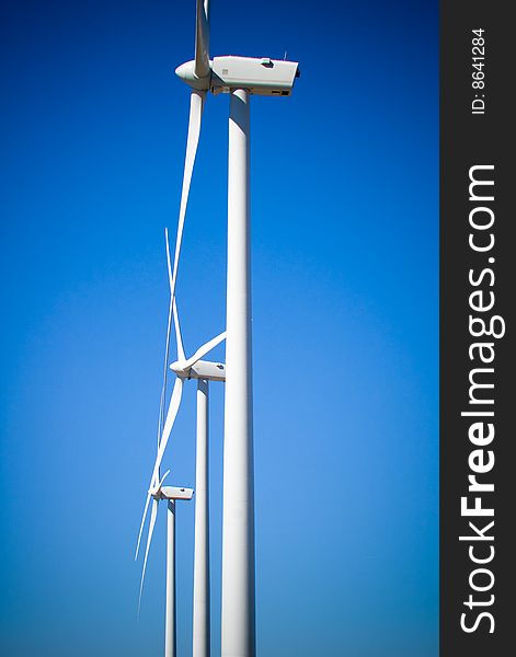 Three wind turbines with blue sky. Three wind turbines with blue sky