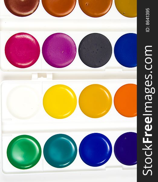 Sixteen different shades of water colour paints in white plastic