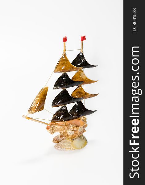 Sailing-vessel from cockle-shells on a white background