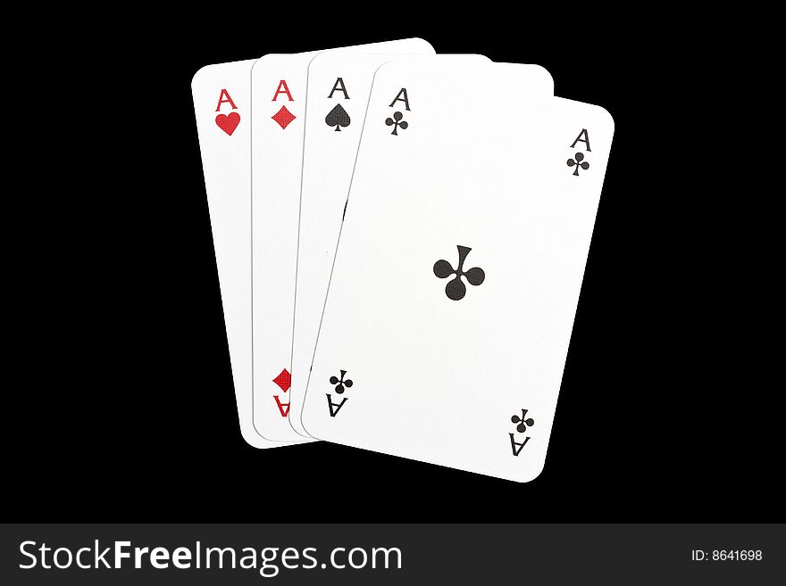 Four aces isolated on black background