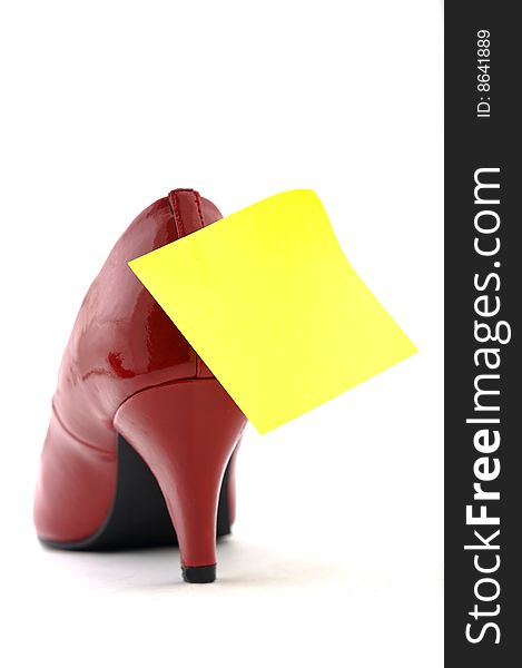 High heel shoe with yellow paper on white background. High heel shoe with yellow paper on white background