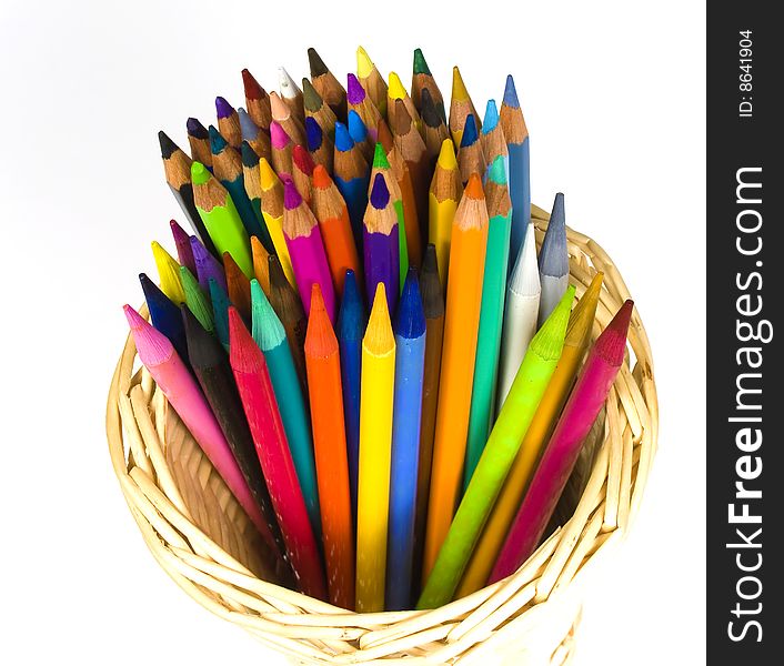 Color wooden and woodless crayons in bast  basket