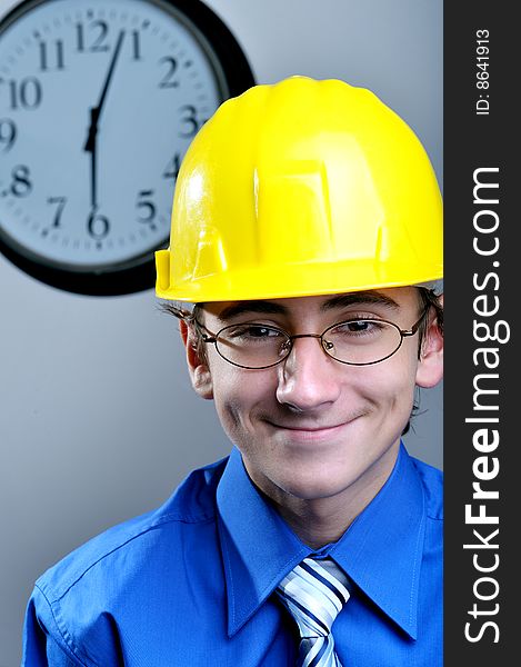 Young engineer wearing hard hat and glasses, close up