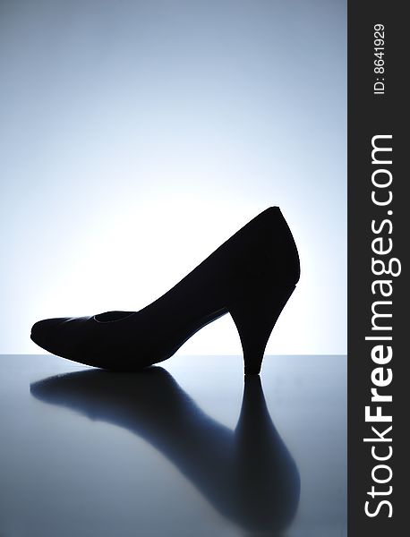 Silhouette of high heel shoe on a table. Silhouette of high heel shoe on a table