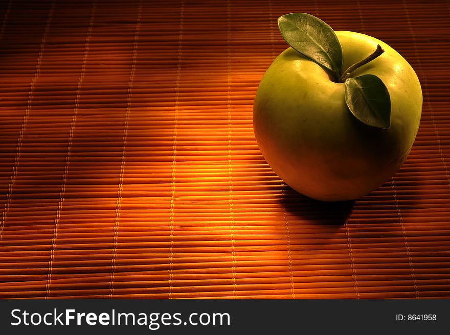 Close up of green apple on wooden background